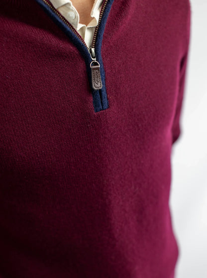 Detail of zip neck jumper from Misty Cashmere in burgundy wine with navy boiled wool trim
