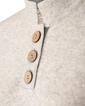 Detail of three large coconut buttons on the high collar jumper in cashmere and merino by Misty Cashmere