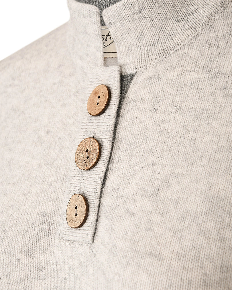Detail of three large coconut buttons on the high collar jumper in cashmere and merino by Misty Cashmere