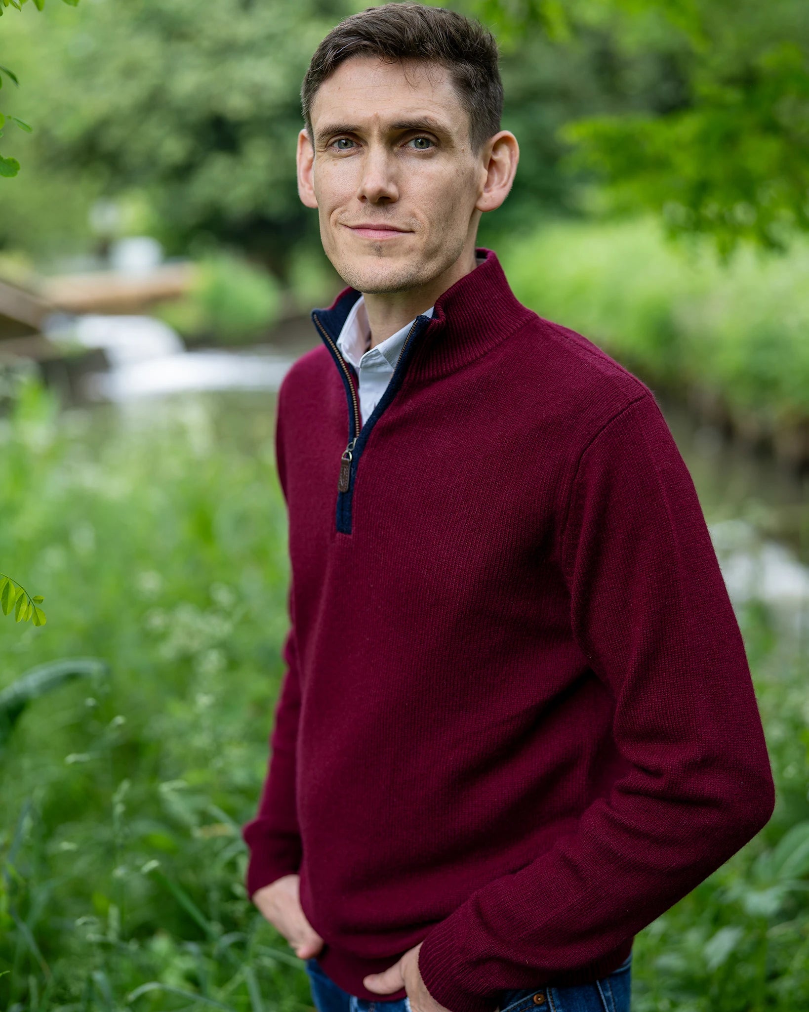 Men's zip neck jumper in cashmere and merino burgundy wine next to the river