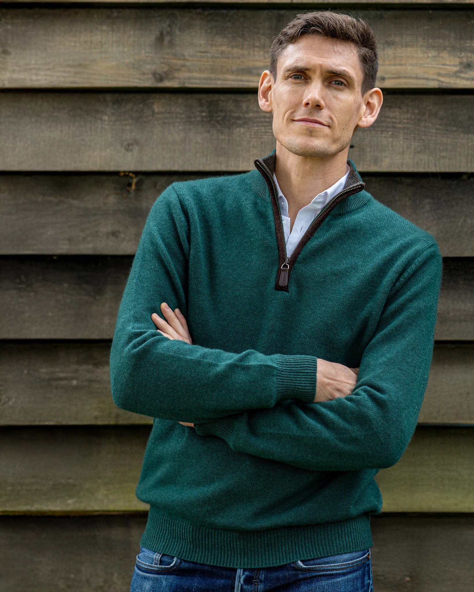 men's zip neck jumper in cashmere and merino with model in front of a fence