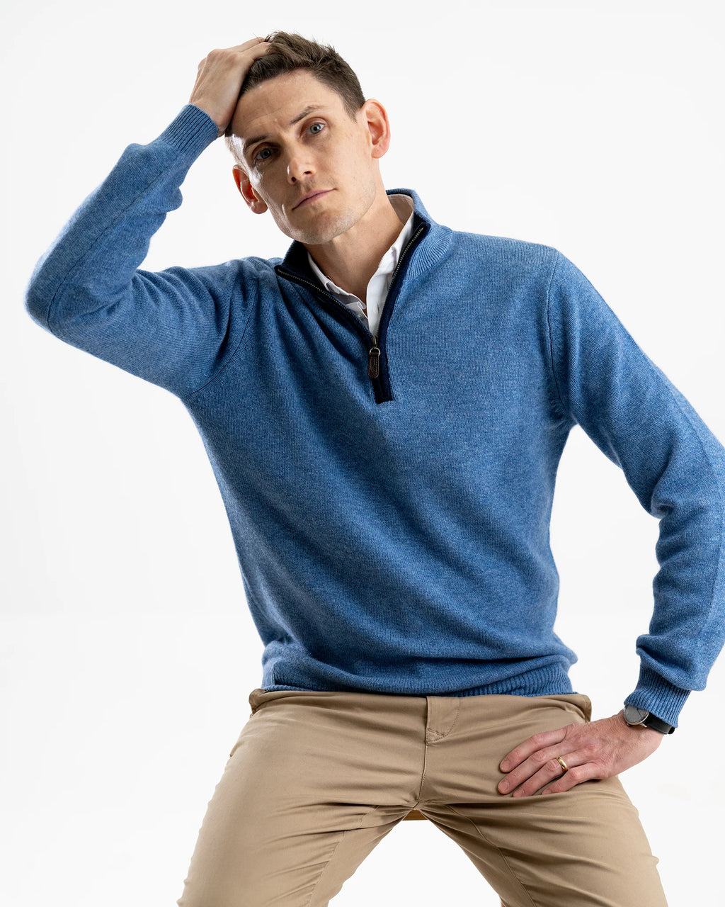 man in studio with cashmere and merino pale blue jumper with navy boiled wool zip trim