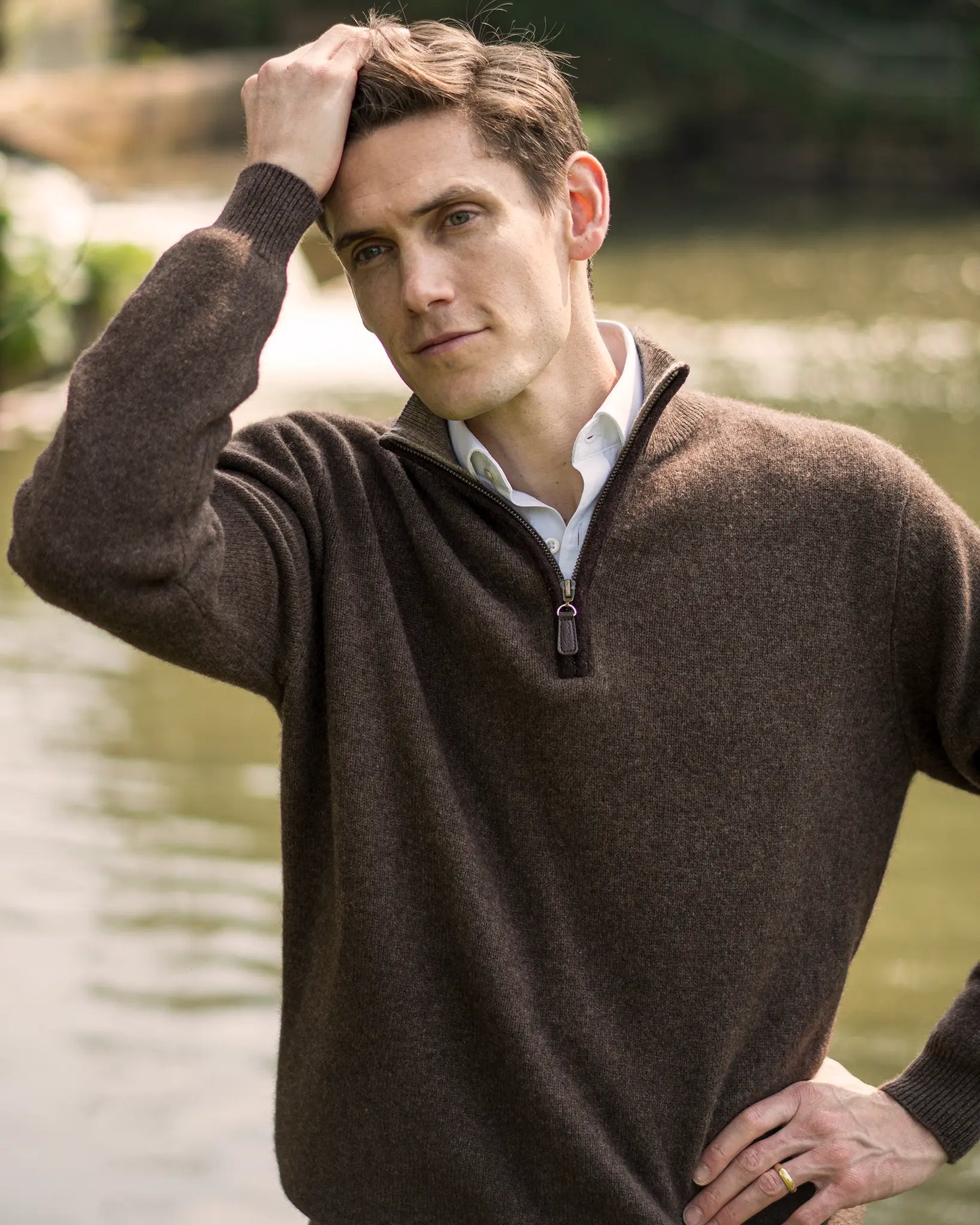 Men's zip neck jumper in yak yarn next to river by Misty Cashmere