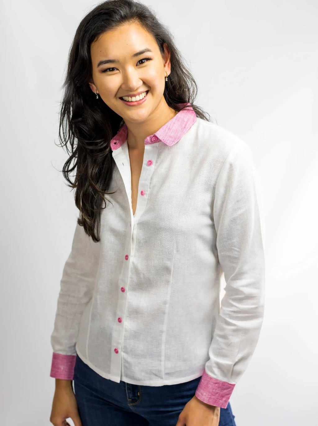 Mode wearing white hemp linen shirt blouse with pink cuffs, collar and corozo buttons.