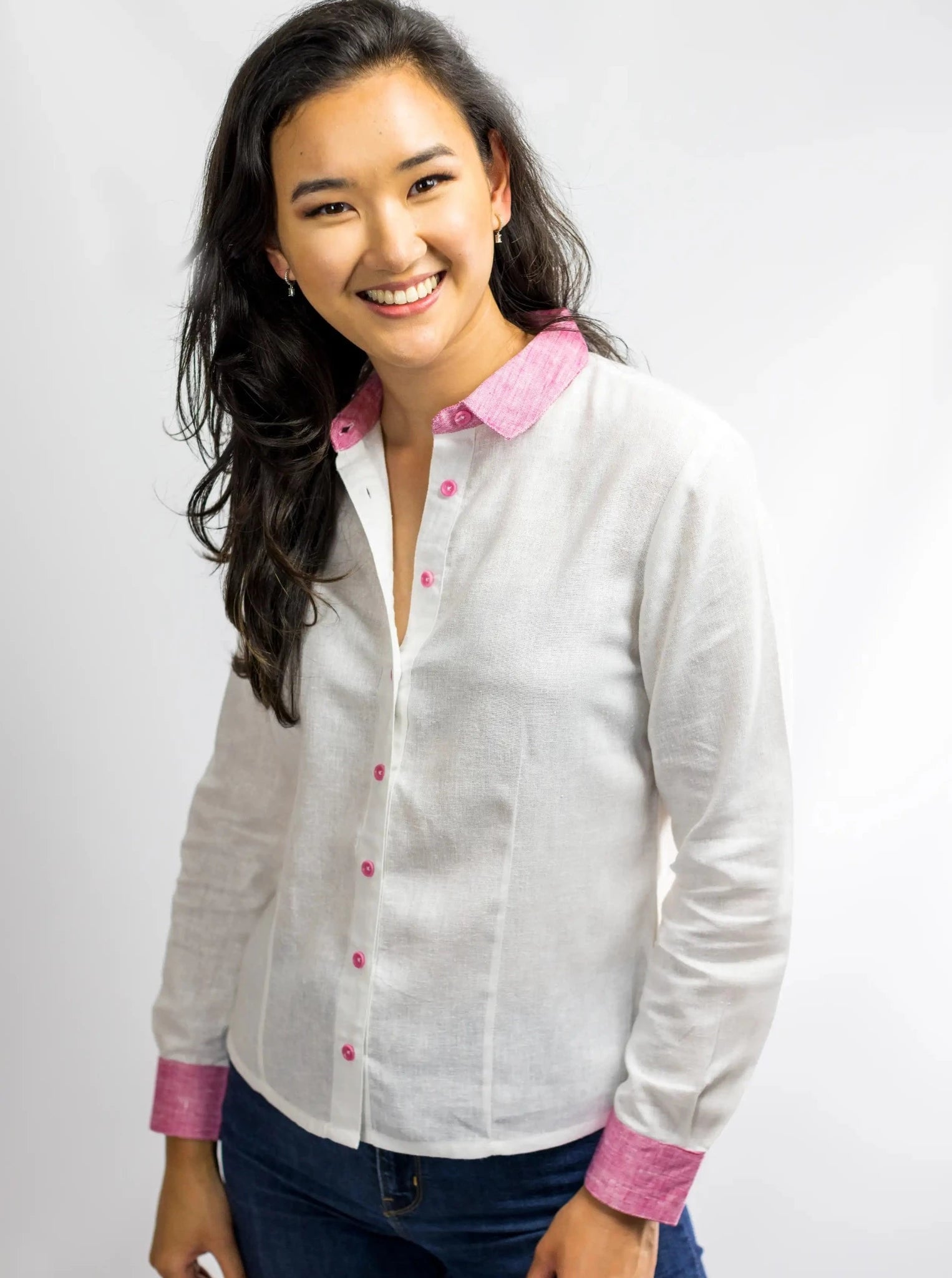Mode wearing white hemp linen shirt blouse with pink cuffs, collar and corozo buttons.