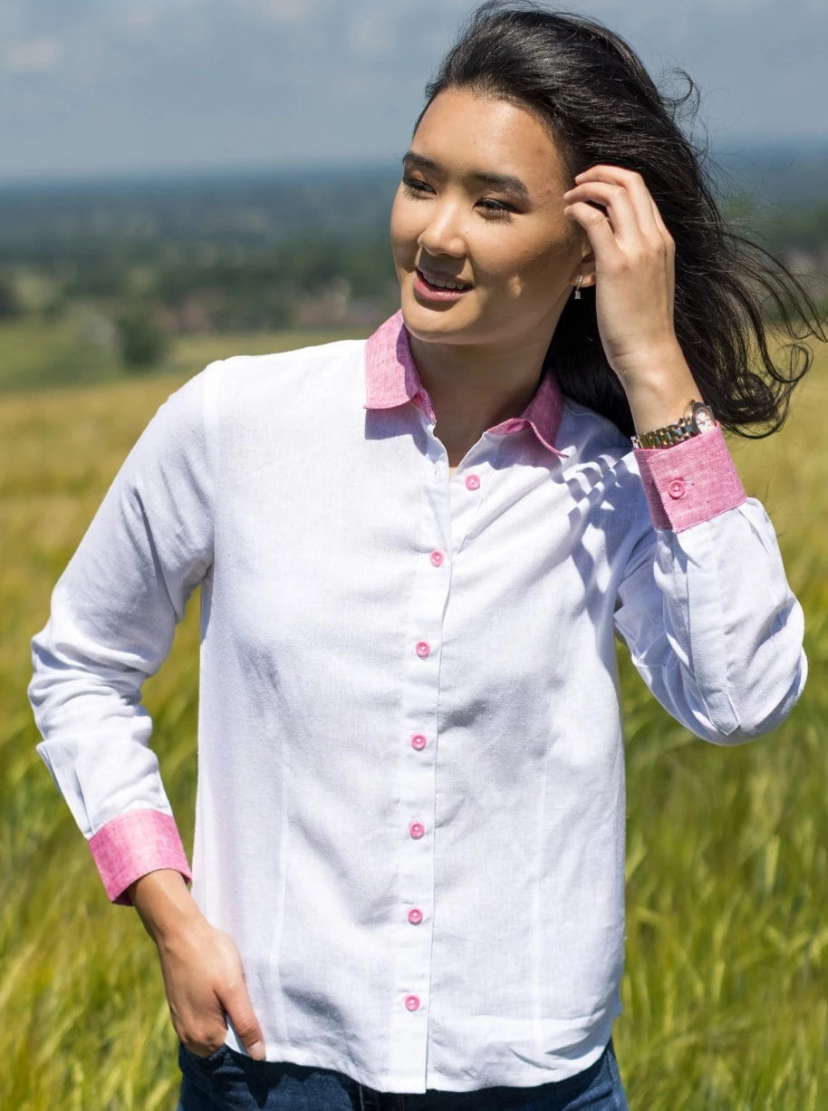 Model wearing white shirt in linen hemp with pink cuffs, collar and corozo buttons.