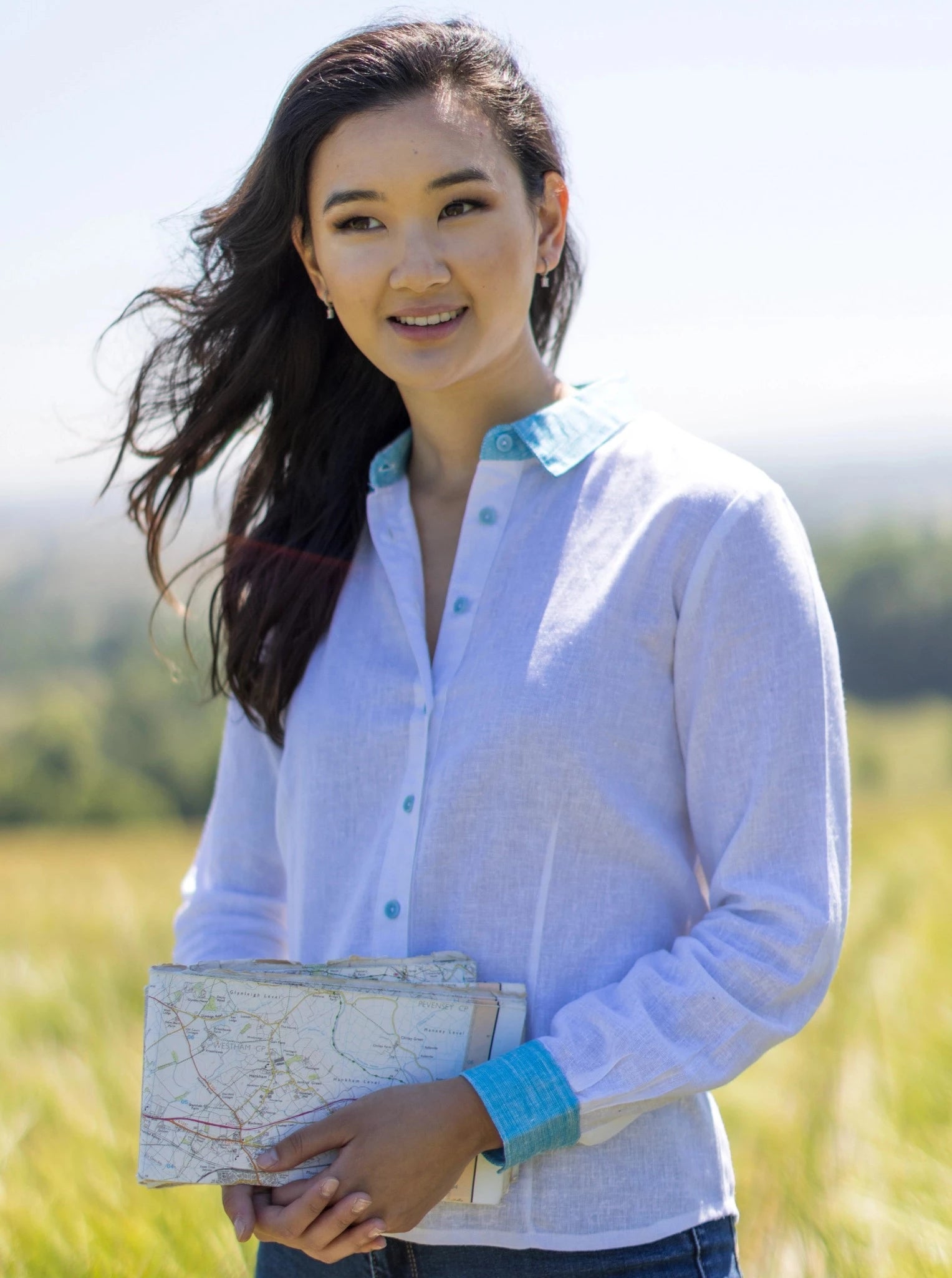 Women's white shirt in hemp and Loycel with turquoise buttons, cuffs and collar in countryside.