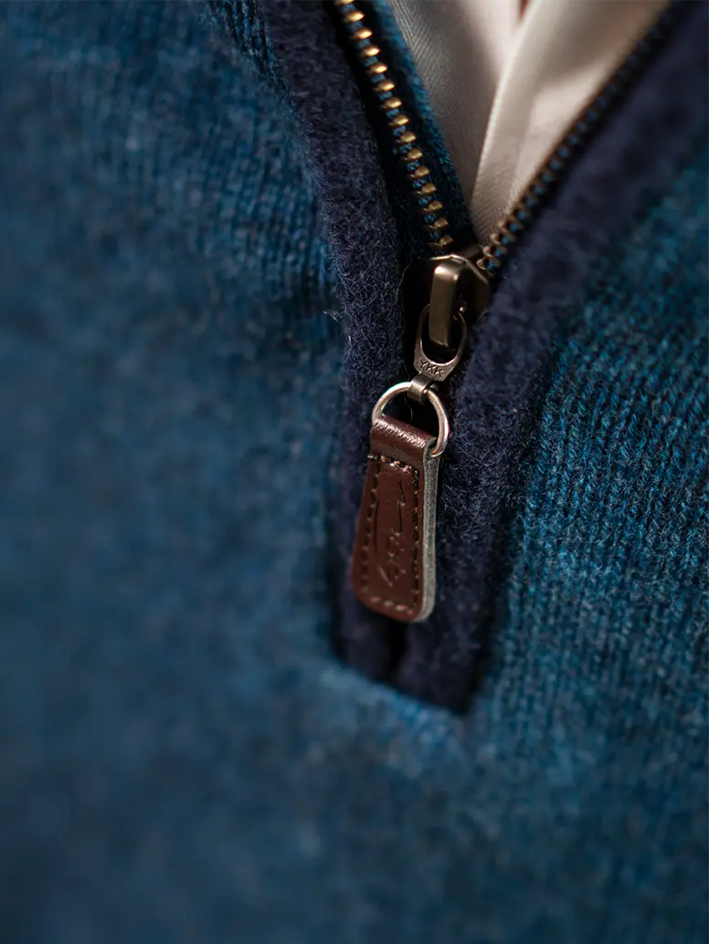 detail of zip on men's quarter zip neck jumper with boiled wool trim and misty cashmere zip pull