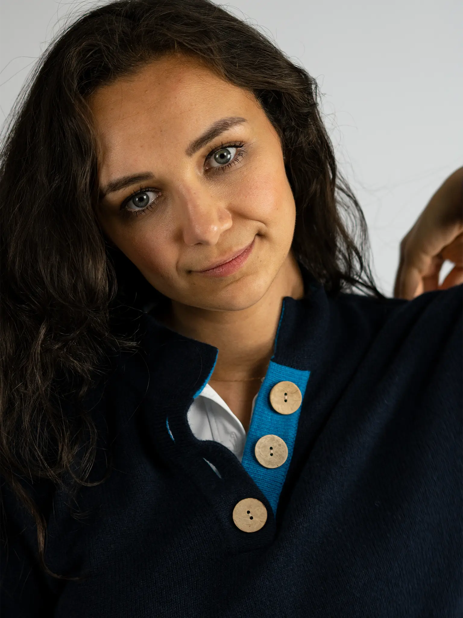 detail of neck opening for the high collar jumper in navy and turquoise from misty cashmere